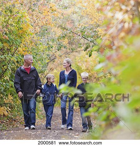 Stock Image - Family Walking Together On A Path In A Park In Autumn; Edmonton Alberta Canada. Fotosearch