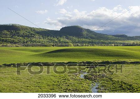 Farm Field Under A Cloudy Sky; Thunder Bay Ontario Canada View Large Photo Image Stock Photograph - Farm Field Under A Cloudy Sky; Thunder Bay Ontario Canada. Fotosearch