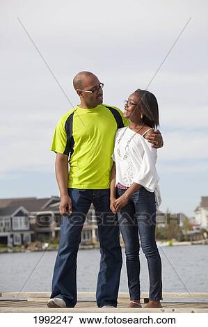 Father And Daughter Talking On A Pier In A Residential Lake Area; Edmonton Alberta Canada View Large Photo Image Stock Photo - Father And Daughter Talking On A Pier In A Residential Lake Area; Edmonton Alberta Canada. Fotosearch