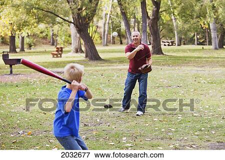 Father And Son Playing Baseball In A Park; Edmonton Alberta Canada View Large Photo Image Stock Photo - Father And Son Playing Baseball In A Park; Edmonton Alberta Canada. Fotosearch