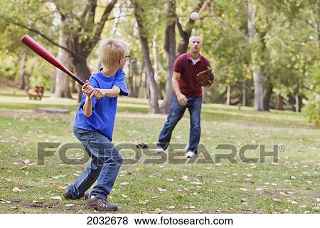 Father And Son Playing Baseball In A Park; Edmonton Alberta Canada View Large Photo Image Stock Photo - Father And Son Playing Baseball In A Park; Edmonton Alberta Canada. Fotosearch