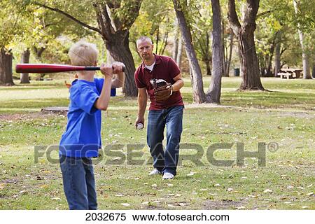 Father And Son Playing Baseball In A Park; Edmonton Alberta Canada View Large Photo Image Stock Photography - Father And Son Playing Baseball In A Park; Edmonton Alberta Canada. Fotosearch