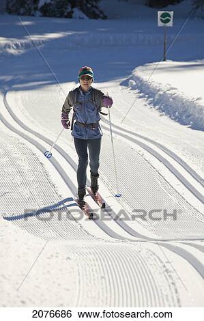 Female cross-country skier on rolling freshly groomed tracks in kananaskis country; alberta canada View Large Photo Image Stock Photograph - Female cross-country skier on rolling freshly groomed tracks in kananaskis country; alberta canada. Fotosearch