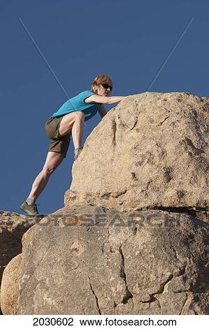 Female Hiker Climbing Up Large Rounded Rock With Deep Blue Sky; Palm Springs California United States Of America View Large Photo Image Stock Image - Female Hiker Climbing Up Large Rounded Rock With Deep Blue Sky; Palm Springs California United States Of America. Fotosearch