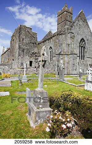 Stock Photo - Flowers Beside A Burial Plot In A Cemetery At Quin Abbey; Quin County Clare Ireland. Fotosearch