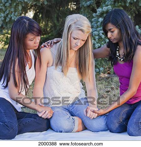 Stock Photo - Friends Holding Hands And Praying Together; Edmonton Alberta Canada. Fotosearch