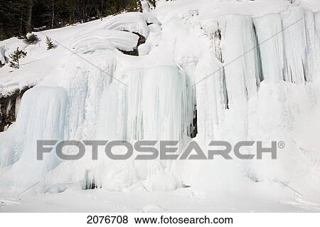 Frozen ice wall and snow covered cliff; alberta canada View Large Photo Image Stock Photo - Frozen ice wall and snow covered cliff; alberta canada. Fotosearch