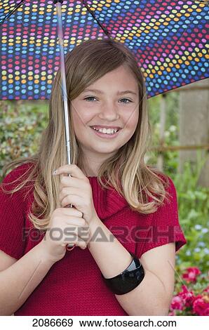 Girl in red dress holding umbrella outside; moraga california united states of america View Large Photo Image Stock Photo - Girl in red dress holding umbrella outside; moraga california united states of america. Fotosearch