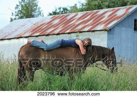 Girl Laying Down On The Back Of A Horse; Troutdale Oregon United States Of America View Large Photo Image Stock Photograph - Girl Laying Down On The Back Of A Horse; Troutdale Oregon United States Of America. Fotosearch