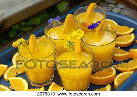 Glasses of orange juice on a tray garnished with slices of orange and flowers; lake of the woods ontario canada View Large Photo Image Stock Image - Glasses of orange juice on a tray garnished with slices of orange and flowers; lake of the woods ontario canada. Fotosearch