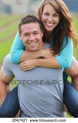 Stock Image - Guy Giving Girl A Piggyback Ride; Troutdale Oregon United States Of America. Fotosearch
