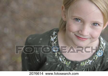 High angle view portrait of a girl with blond hair and green eyes; troutdale oregon united states of america View Large Photo Image Picture - High angle view portrait of a girl with blond hair and green eyes; troutdale oregon united states of america. Fotosearch