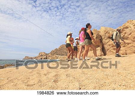 Stock Photograph - Hikers On A Desert Trail Along The Ocean; San Jose Del Cabo Baja California Sur Mexico. Fotosearch
