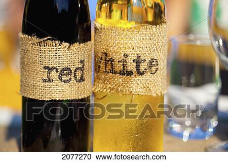 Stock Image - Homemade wine bottles with burlap labels; vancouver british columbia canada. Fotosearch