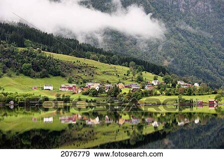 Houses in a valley along the water with low cloud; granvin norway View Large Photo Image Stock Photo - Houses in a valley along the water with low cloud; granvin norway. Fotosearch
