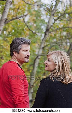 Stock Image - Husband And Wife Together In A Park In Autumn; St. Albert Alberta Canada. Fotosearch