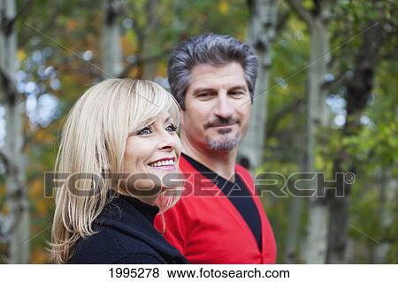 Stock Photo - Husband And Wife Together In A Park In Autumn; St. Albert Alberta Canada. Fotosearch