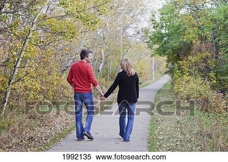 Husband And Wife Walking In A Park In Autumn; St. Albert Alberta Canada View Large Photo Image Stock Photography - Husband And Wife Walking In A Park In Autumn; St. Albert Alberta Canada. Fotosearch