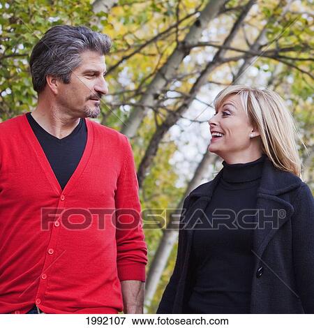 Stock Photo - Husband And Wife Walking In The Park During Autumn; St. Albert Alberta Canada. Fotosearch