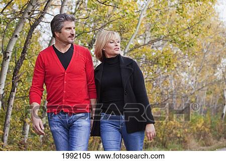 Husband And Wife Walking In The Park During Autumn; St. Albert Alberta Canada View Large Photo Image Stock Photography - Husband And Wife Walking In The Park During Autumn; St. Albert Alberta Canada. Fotosearch