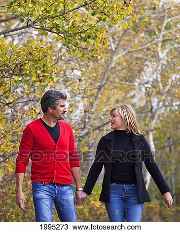 Husband And Wife Walking Together In A Park In Autumn; St. Albert Alberta Canada View Large Photo Image Stock Image - Husband And Wife Walking Together In A Park In Autumn; St. Albert Alberta Canada. Fotosearch