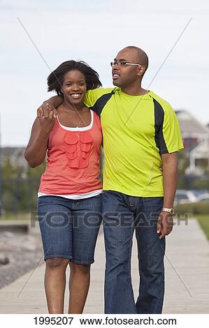 Stock Photo - Husband And Wife Walking Together In A Residential Lake Area; Edmonton Alberta Canada. Fotosearch