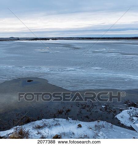 Ice and snow with clouds reflected in the water along the shoreline of hudson bay; churchill manitoba canada View Large Photo Image Stock Photo - Ice and snow with clouds reflected in the water along the shoreline of hudson bay; churchill manitoba canada. Fotosearch