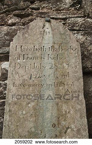 Stock Image - Inscription On An Old Tombstone; Ireland. Fotosearch