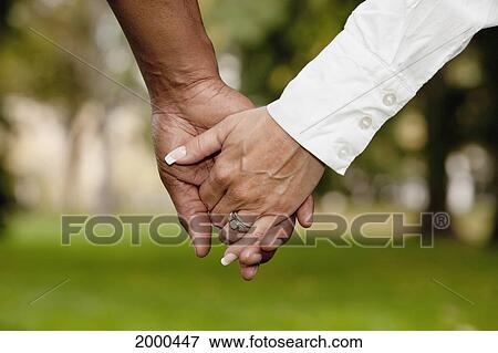 Inter-Racial Couple Holding Hands; Edmonton Alberta Canada View Large Photo Image Stock Photo - Inter-Racial Couple Holding Hands; Edmonton Alberta Canada. Fotosearch