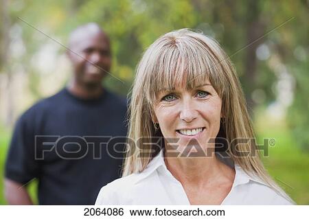 Stock Photograph - Interracial Couple Posing In The Park; Edmonton Alberta Canada. Fotosearch