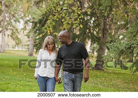 Interracial Married Couple Walking In A Park In Autumn; Edmonton Alberta Canada View Large Photo Image Stock Photo - Interracial Married Couple Walking In A Park In Autumn; Edmonton Alberta Canada. Fotosearch