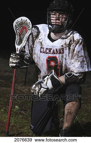 Lacrosse player kneeling on ground; troutdale oregon united states of america View Large Photo Image Stock Photo - Lacrosse player kneeling on ground; troutdale oregon united states of america. Fotosearch