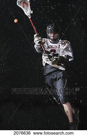 Lacrosse player playing in the rain at night; troutdale oregon united states of america View Large Photo Image Stock Photograph - Lacrosse player playing in the rain at night; troutdale oregon united states of america. Fotosearch