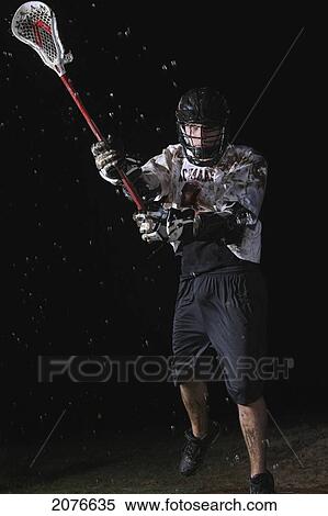 Lacrosse player playing in the rain at night; troutdale oregon united states of america View Large Photo Image Stock Photography - Lacrosse player playing in the rain at night; troutdale oregon united states of america. Fotosearch