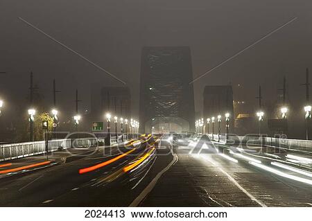 Stock Image - Light Trails Of Vehicle Headlights And Tail Lights On A Busy Road Leading To A Bridge At Night; Newcastle Northumberland England. Fotosearch