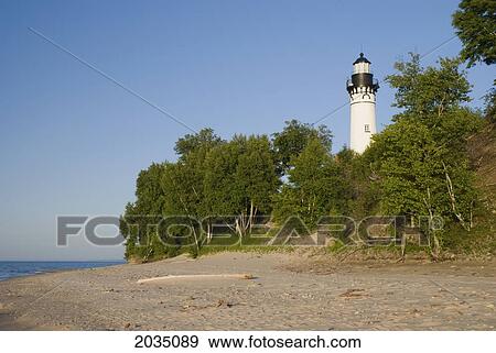 Stock Photo - Lighthouse Viewed From A Sandy Beach; Michigan United States Of America. Fotosearch