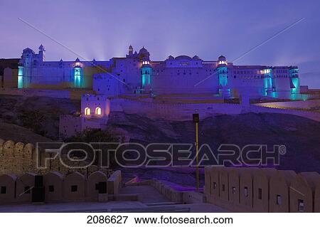 Lights illuminate a building at dusk; jaipur rajasthan india View Large Photo Image Stock Photo - Lights illuminate a building at dusk; jaipur rajasthan india. Fotosearch