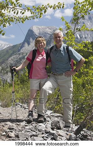 Male And Female Hikers With Mountains In The Background; Alberta Canada View Large Photo Image Picture - Male And Female Hikers With Mountains In The Background; Alberta Canada. Fotosearch