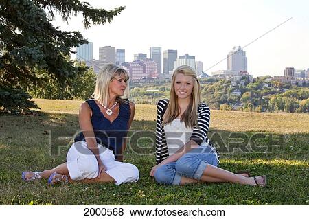 Mother And Daughter Spending Time Together In A Park With The City Skyline In The Background; Edmonton Alberta Canada View Large Photo Image Stock Photo - Mother And Daughter Spending Time Together In A Park With The City Skyline In The Background; Edmonton Alberta Canada. Fotosearch