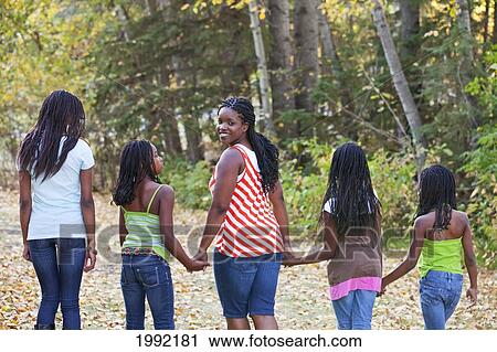 Stock Image - Mother And Daughters Walking In A Park; Edmonton Alberta Canada. Fotosearch