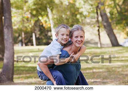 Stock Image - Mother And Son Spending Quality Time Together In A Park In Autumn; Edmonton Alberta Canada. Fotosearch