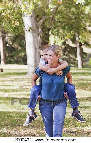 Mother And Son Spending Quality Time Together In A Park In Autumn; Edmonton Alberta Canada View Large Photo Image Stock Image - Mother And Son Spending Quality Time Together In A Park In Autumn; Edmonton Alberta Canada. Fotosearch