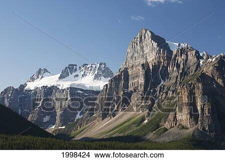 Mountain Peaks With Cliff Face And Blue Sky; Alberta Canada View Large Photo Image Picture - Mountain Peaks With Cliff Face And Blue Sky; Alberta Canada. Fotosearch
