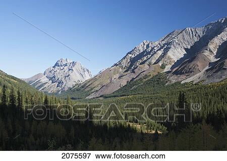 Mountain Range And Valley With Blue Sky; Alberta Canada View Large Photo Image Stock Photo - Mountain Range And Valley With Blue Sky; Alberta Canada. Fotosearch