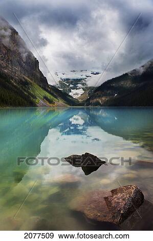 Mountains reflected in tranquil lake louise; alberta canada View Large Photo Image Stock Photo - Mountains reflected in tranquil lake louise; alberta canada. Fotosearch