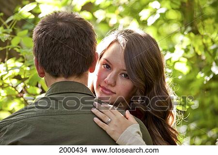 Picture - Newlywed Couple Embracing In A Park; Edmonton Alberta Canada. Fotosearch