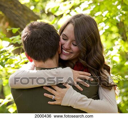 Newlywed Couple Embracing In A Park; Edmonton Alberta Canada View Large Photo Image Stock Photograph - Newlywed Couple Embracing In A Park; Edmonton Alberta Canada. Fotosearch