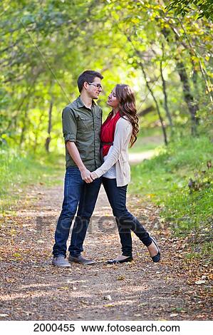 Newlywed Couple Spending Time Together In A Park In Autumn; Edmonton Alberta Canada View Large Photo Image Stock Photography - Newlywed Couple Spending Time Together In A Park In Autumn; Edmonton Alberta Canada. Fotosearch