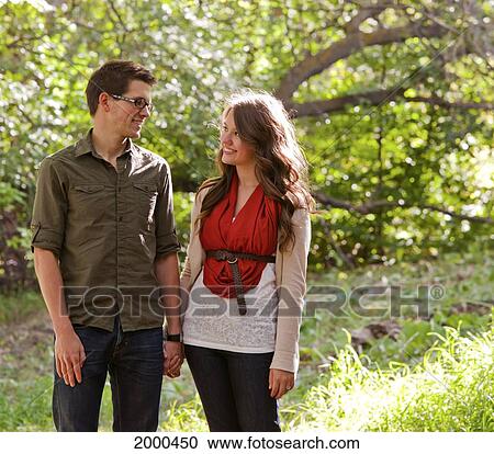 Stock Image - Newlywed Couple Walking In A Park In Autumn; Edmonton Alberta Canada. Fotosearch