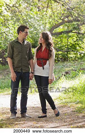 Newlywed Couple Walking In A Park In Autumn; Edmonton Alberta Canada View Large Photo Image Stock Photo - Newlywed Couple Walking In A Park In Autumn; Edmonton Alberta Canada. Fotosearch